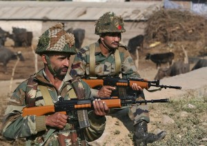 Indian army soldiers stand guard near the Indian Air Force (IAF) base at Pathankot in Punjab, India, January 3, 2016. A gold medal-winning Indian shooter was among 10 people killed in an audacious pre-dawn assault on the air force base, officials said on Sunday as troops worked to clear the compound near India's border with Pakistan after a 15-hour gunbattle. REUTERS/Mukesh Gupta - RTX20UF5