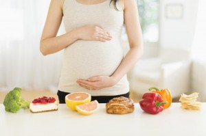 Health and unhealthy foods in front of pregnant Japanese woman